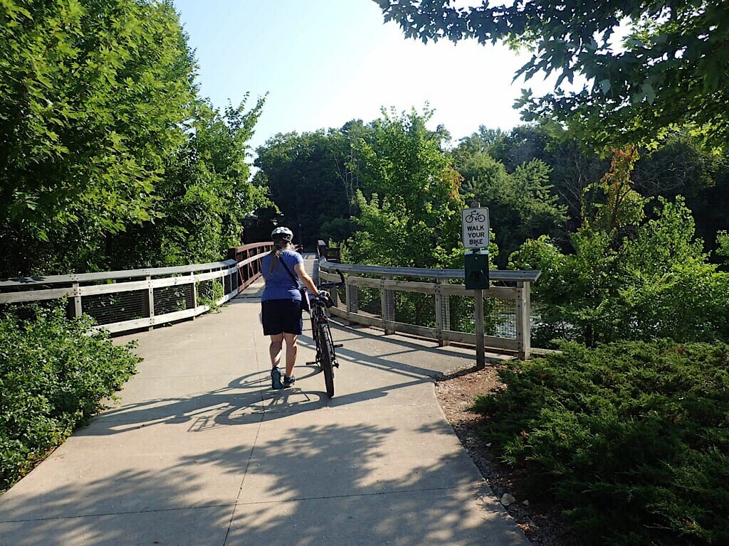 Pushing bike over Riverwalk bridge