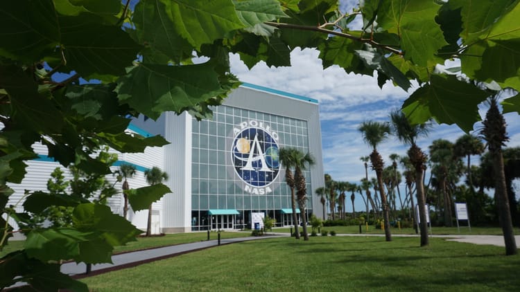 Space center building framed by arc of sycamore leaves