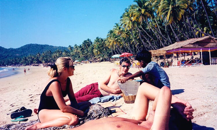 Young man talking to beachgoers