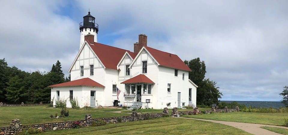 Lighthouse with red roofs and stone walls