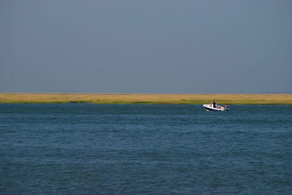 Lone boat in a vast estuary